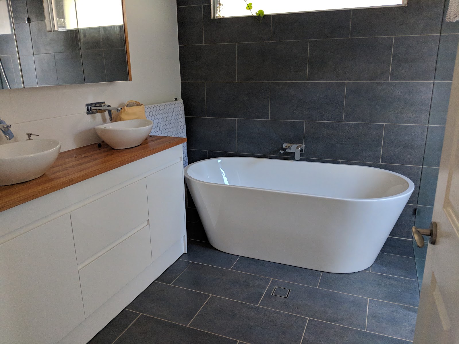 Completed bathroom renovation with freestanding bath