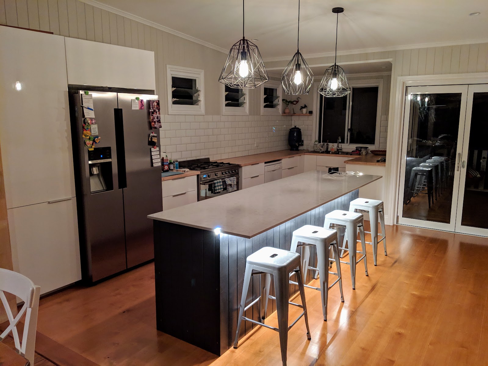 Completed kitchen renovation with island bench and pendant lights